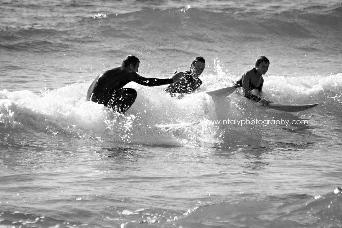 3 surfeurs père et fils sur la même vague